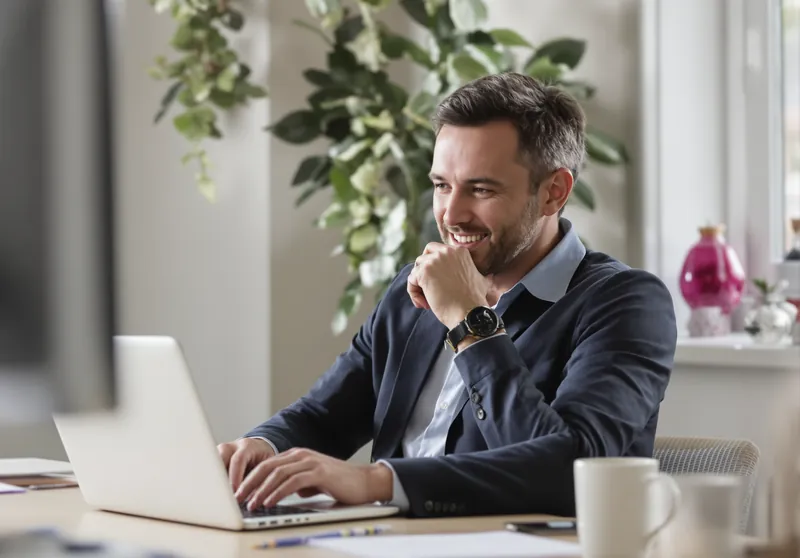A business owner reviewing his company's profile on a laptop